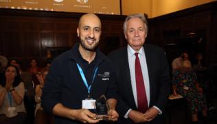 Photo shows Faycal Lasri and Charles Alexander at the CARE awards. They are both smiling.