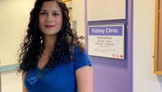 Dr Sumoyee Basu, wearing a blue top, is standing outside the Kidney Clinic at Guy's Hospital