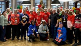 The catering team at St Thomas' hospital, together with volunteers with Guy's & St Thomas' Charity, in a group photo at the Shephard's Hall Christmas lunch for staff.