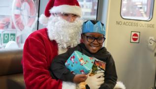 Santa with an Evelina London patient on a boat. 