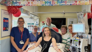 Mica with family and Harefield members of staff. She is in the middle of the photo connected to an apheresis machine.