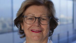 Headshot of Dr Penelope Shirlaw. She has light brown shoulder length hair and is wearing glasses. 