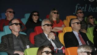 People watching a film in a cinema wearing 3D glasses