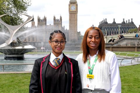 Student, Breanna, pictured with Aspire 350 project lead Hayley Robinson-Allen, in the gardens at St Thomas'. It is a sunny day and Big Ben is behind them. 