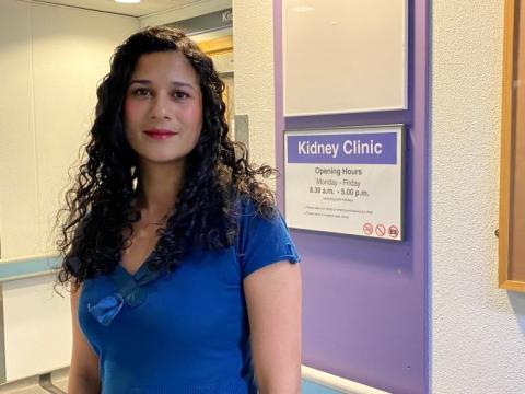 Dr Sumoyee Basu, wearing a blue top, is standing outside the Kidney Clinic at Guy's Hospital