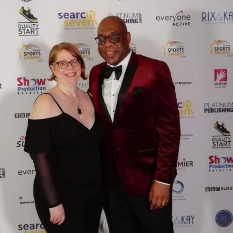 Eric Douglin, wearing a dinner suit, is standing next to wife Mandi, who is in a black evening dress.