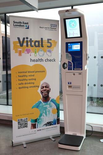 Image shows picture of Vital 5 health check kiosk in Gassiot House outpatients reception area.