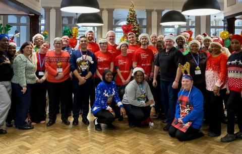 The catering team at St Thomas' hospital, together with volunteers with Guy's & St Thomas' Charity, in a group photo at the Shephard's Hall Christmas lunch for staff.