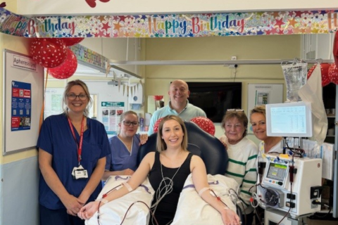 Mica with family and Harefield members of staff. She is in the middle of the photo connected to an apheresis machine.